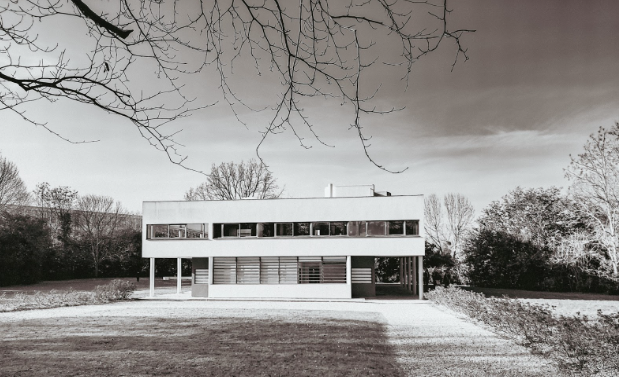 Villa Savoye by Le Corbusier: Subtle flat mouldings blend into walls and ceilings, used sparingly, concealing transitions to maintain a polished look. Low, crisped lined baseboards protect the walls while making the room feel taller and more expansive. Window sills were treated in an understated, functional way with painted wood or flat, simplified mouldings aligned with the adjacent surface. Located in Poissy, France.