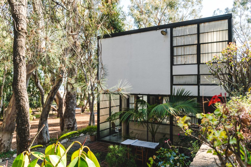 Clean, functional woodwork complement the modular design of this mid-century modern masterpiece, seamlessly integrating with the combination of steel, glass, and wood materials. The look of wood panels featured in the interior here can also be achieved by custom fabricated wood tongue and groove planks with eased edges, leaving narrow gaps. Established in Pacific Palisades, California.