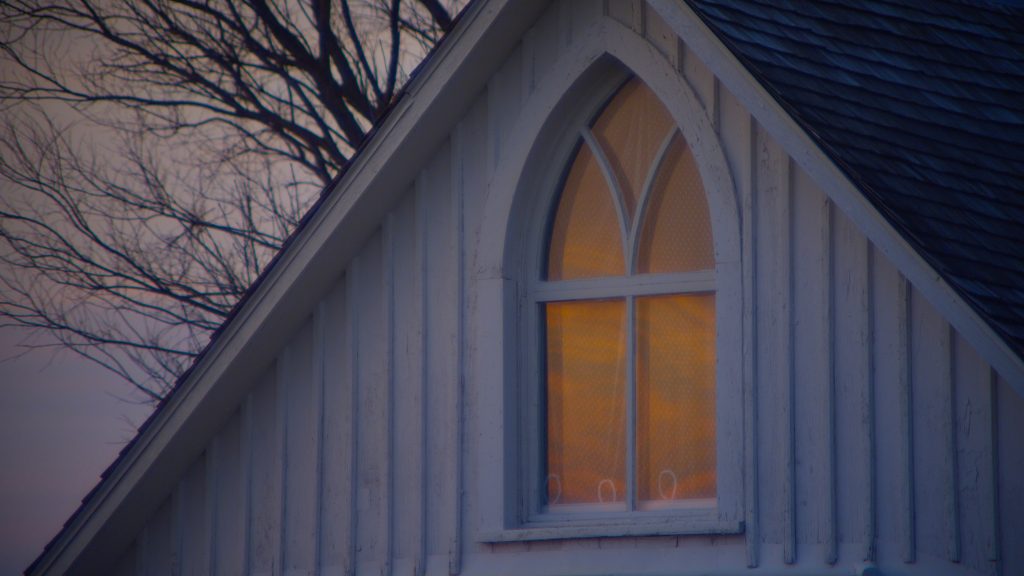 winter's,sunset,is,reflected,in,the,gothic,window,of,the