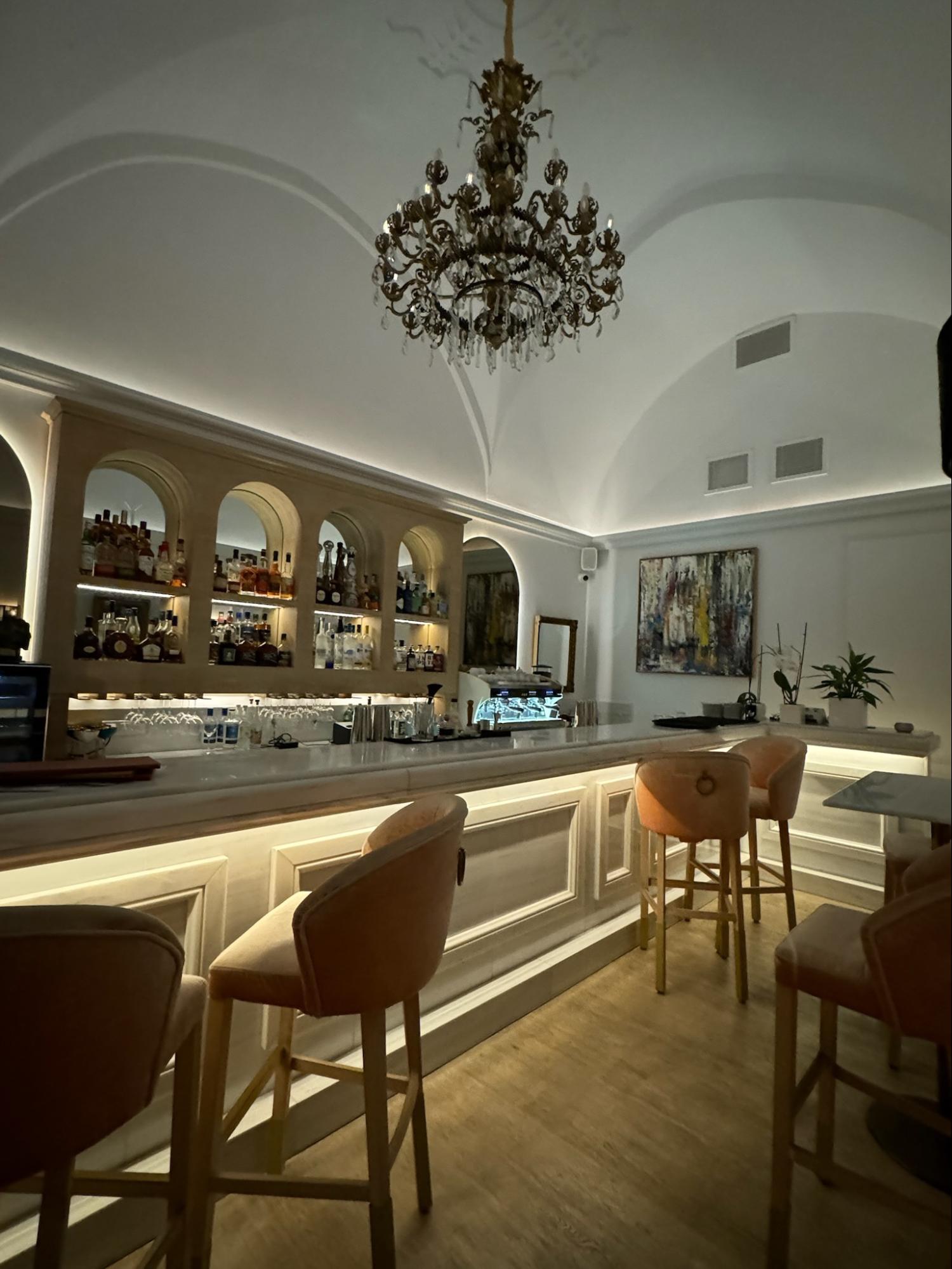 Location: Restaurant Naos, Santorini, Oia, GreeceWood Highlights: Trim at cabinetry and wainscot, placed to allow recessed lighting