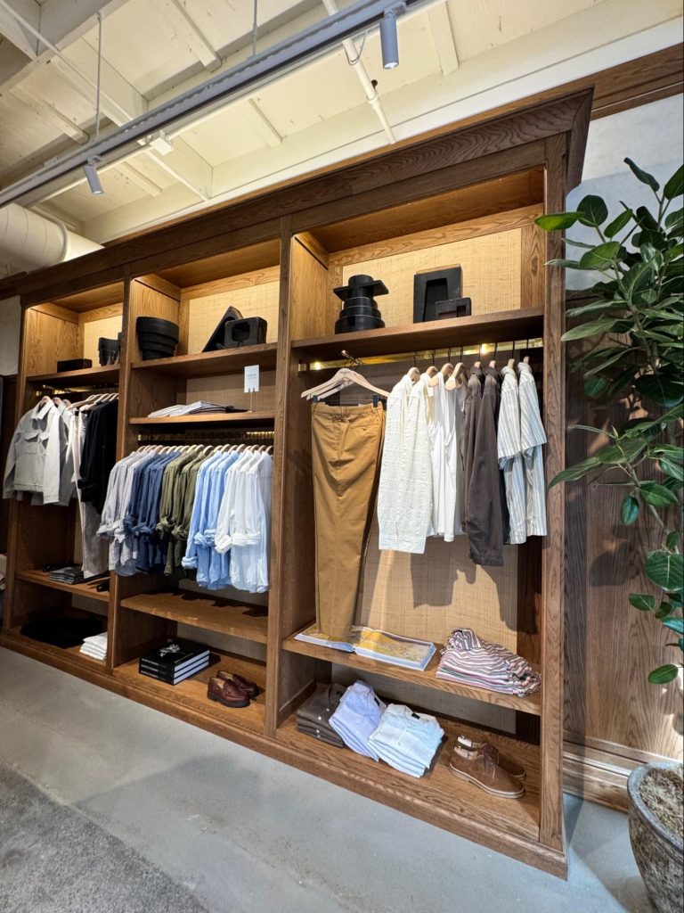 Location: Todd Snyder, Marin County, California, Wood Highlights: Flat eased edge oak moulding at edge of S4S shelving at front and back with wallcovering fabric, offset edges, and crown moulding above