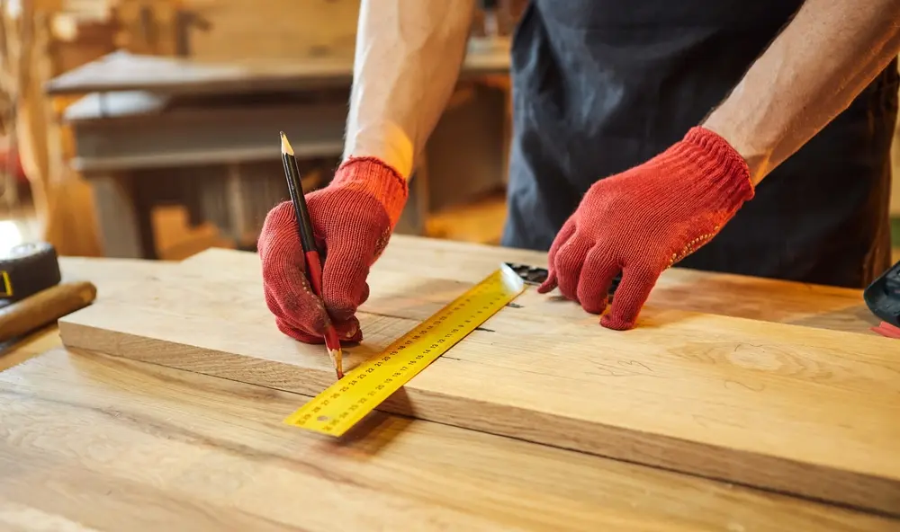 Wood Highlights: Wood worker measures for precision before milling