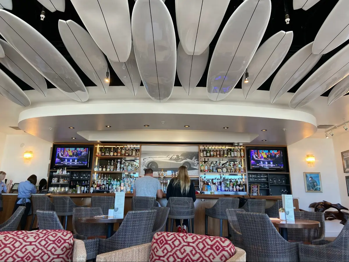 Location: Jack O’Neil Lounge, Santa Cruz, California,Wood Highlights: Warm wood trim at face of bar and wood edge at counter, wood at bar back elevation