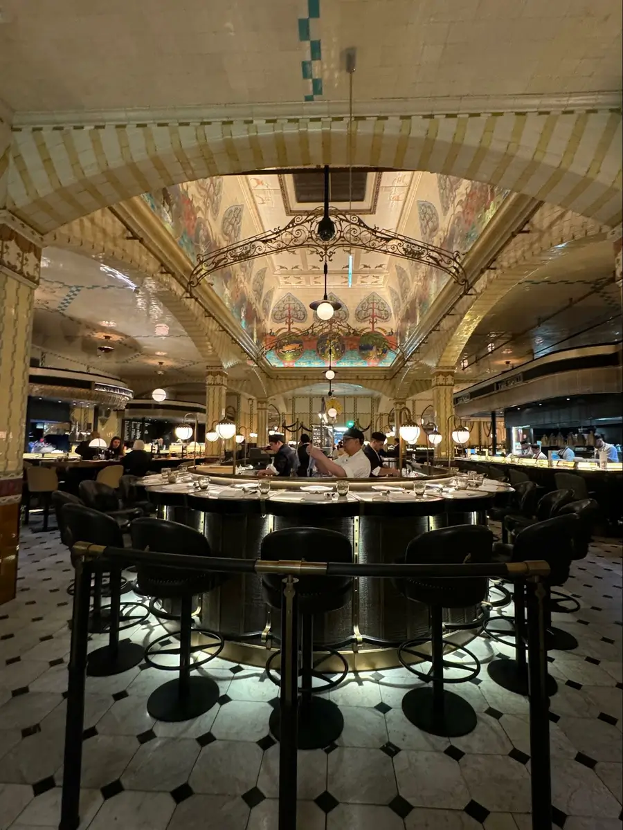 Photo credit: MetaphorDesign.com, Location: Harrods Dining Hall, London, Wood Highlights: Warm wood trim at face of bar and wood edge at counter