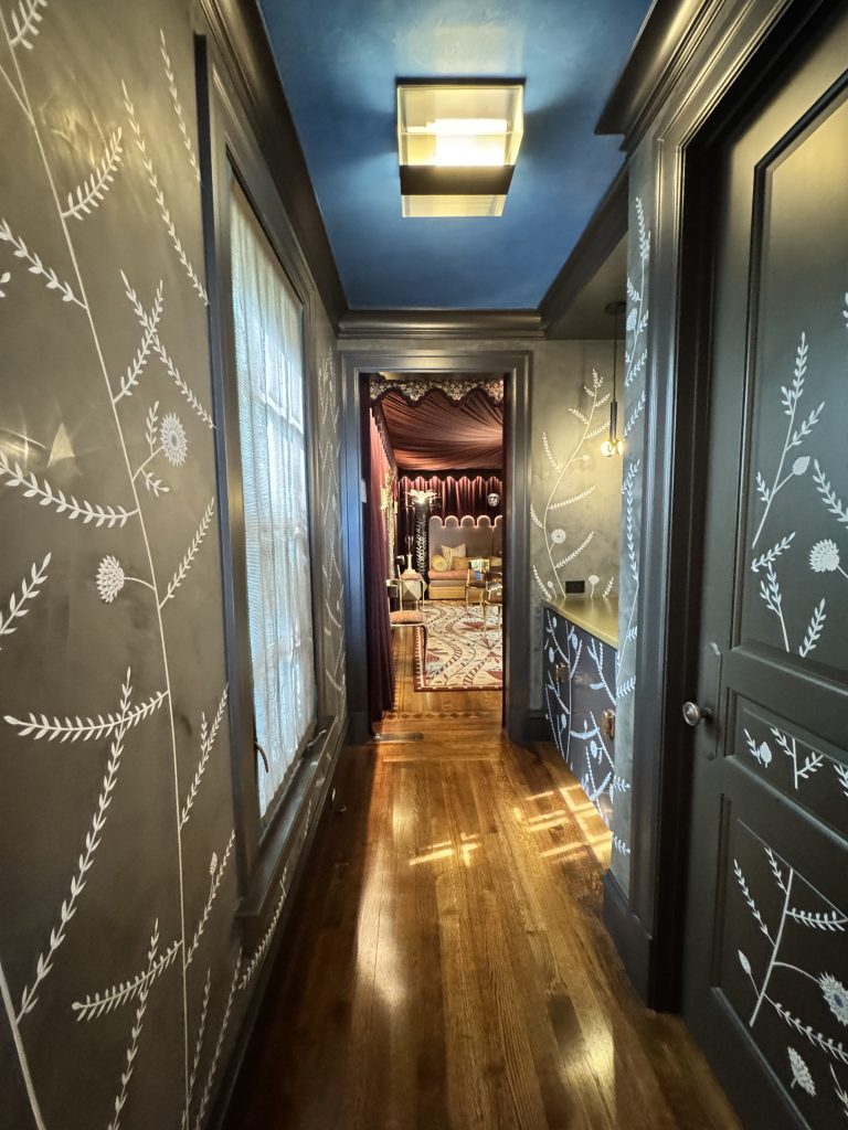 Photo credit: Metaphor Edge, Location: Private Residence, San Francisco, California, Wood Highlights: Black painted crown moulding, door frames, window frame, window sill, baseboards with a white floral motif painted on wood
