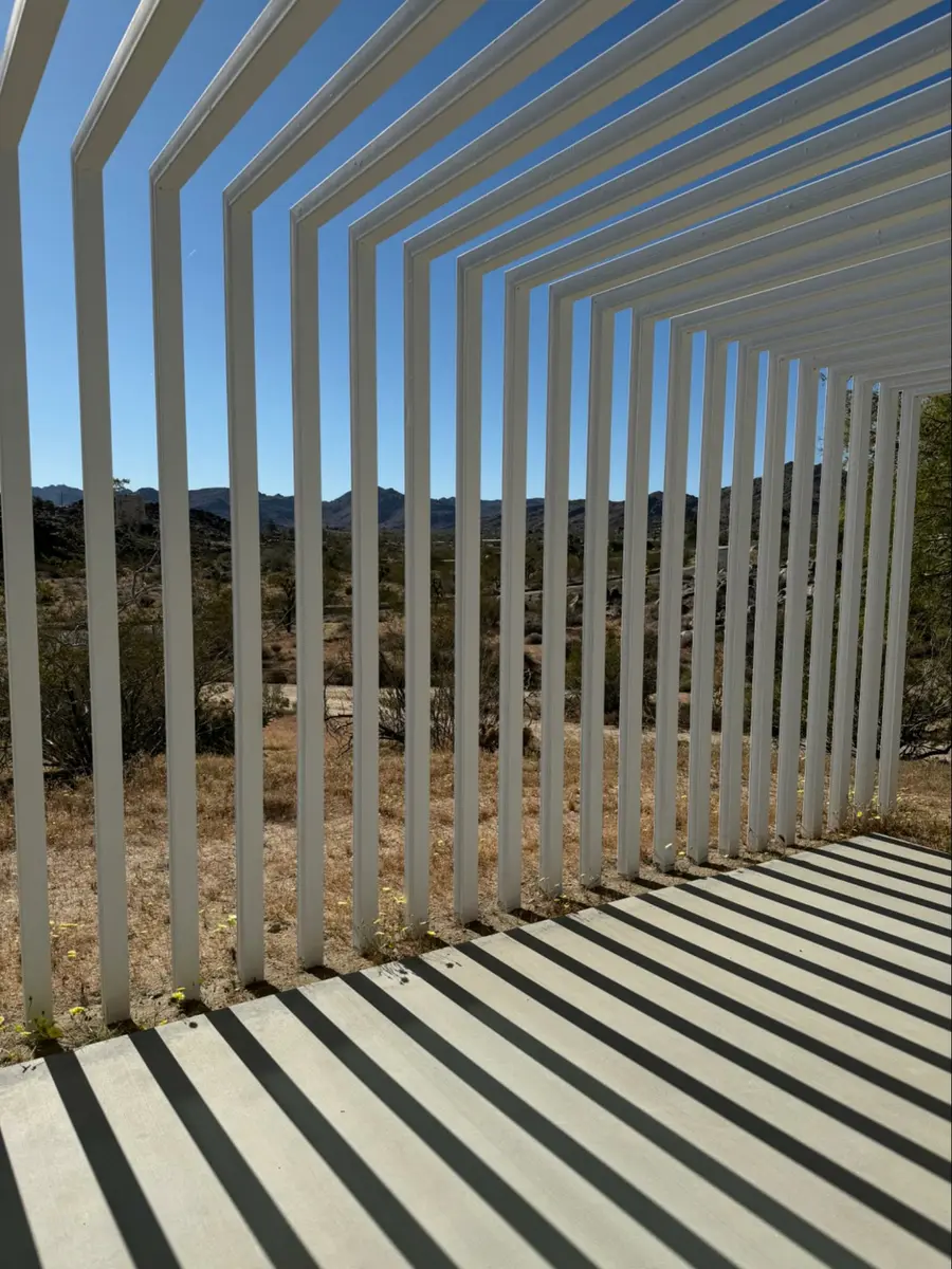 Photo credit: MetaphorEdge.com, Location: Private Residence, Joshua Tree, California, Wood Highlights: Vertical and horizontal S4S members cast shifting shadows throughout the day, turning a functional shade structure into an ever-changing art piece