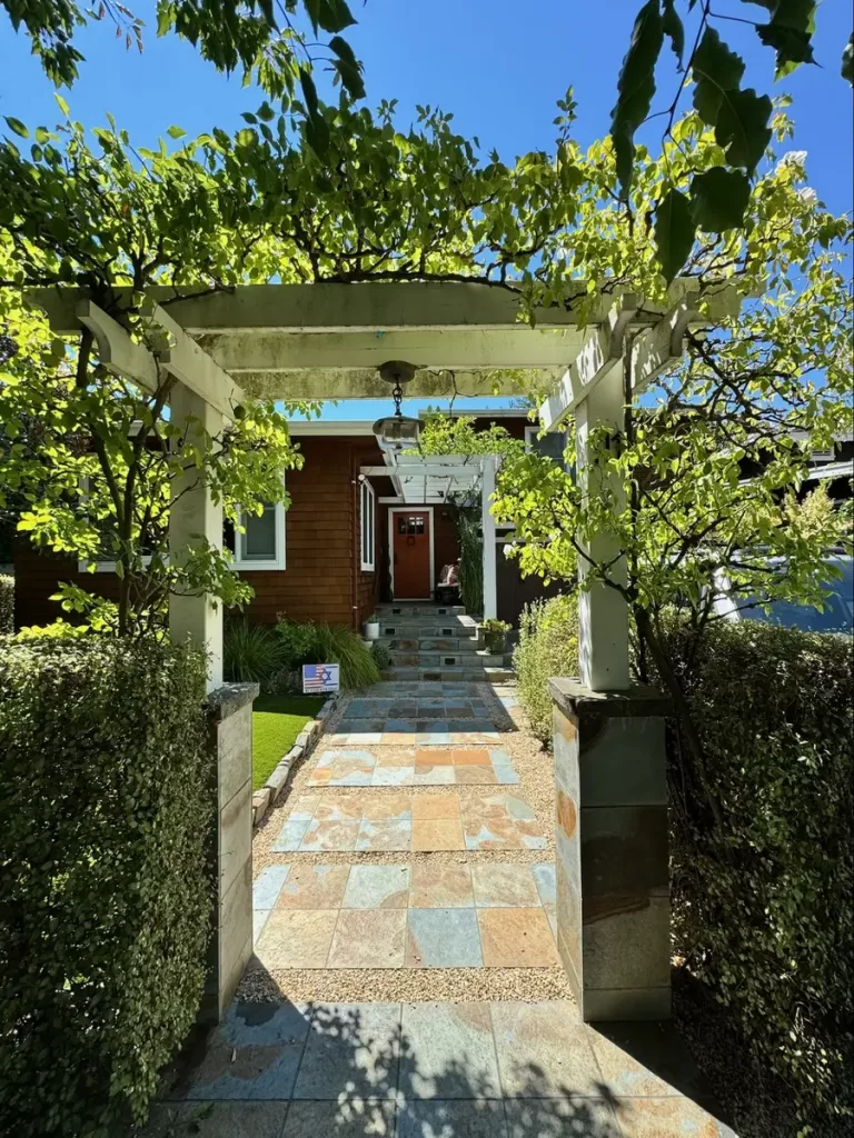 Location: Marin County, California, Wood Highlights: A small white arbor of S4S sharply frames a garden entry with lighting
