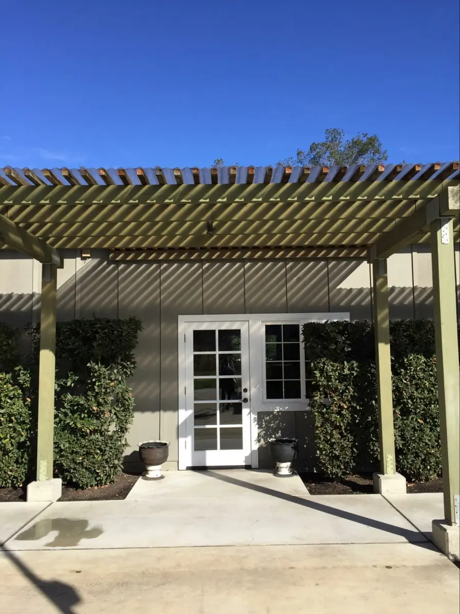 Photo credit: MetaphorEdge.com, Location: Farmstead, Napa, California, Wood Highlights: Painted members of modern pergola filter the hot sun over the dining area framing distant desert views as well