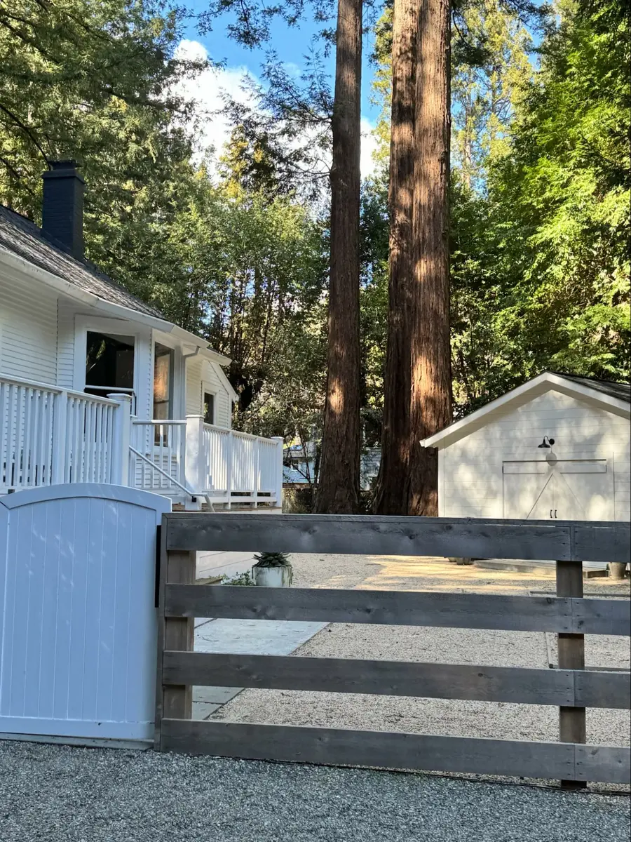 Photo credit: Metaphor Design, Location: Marin County, California, Wood Highlights: This backyard ADU is detailed to match the main original farmhouse building base siding with matching Rustic V siding
