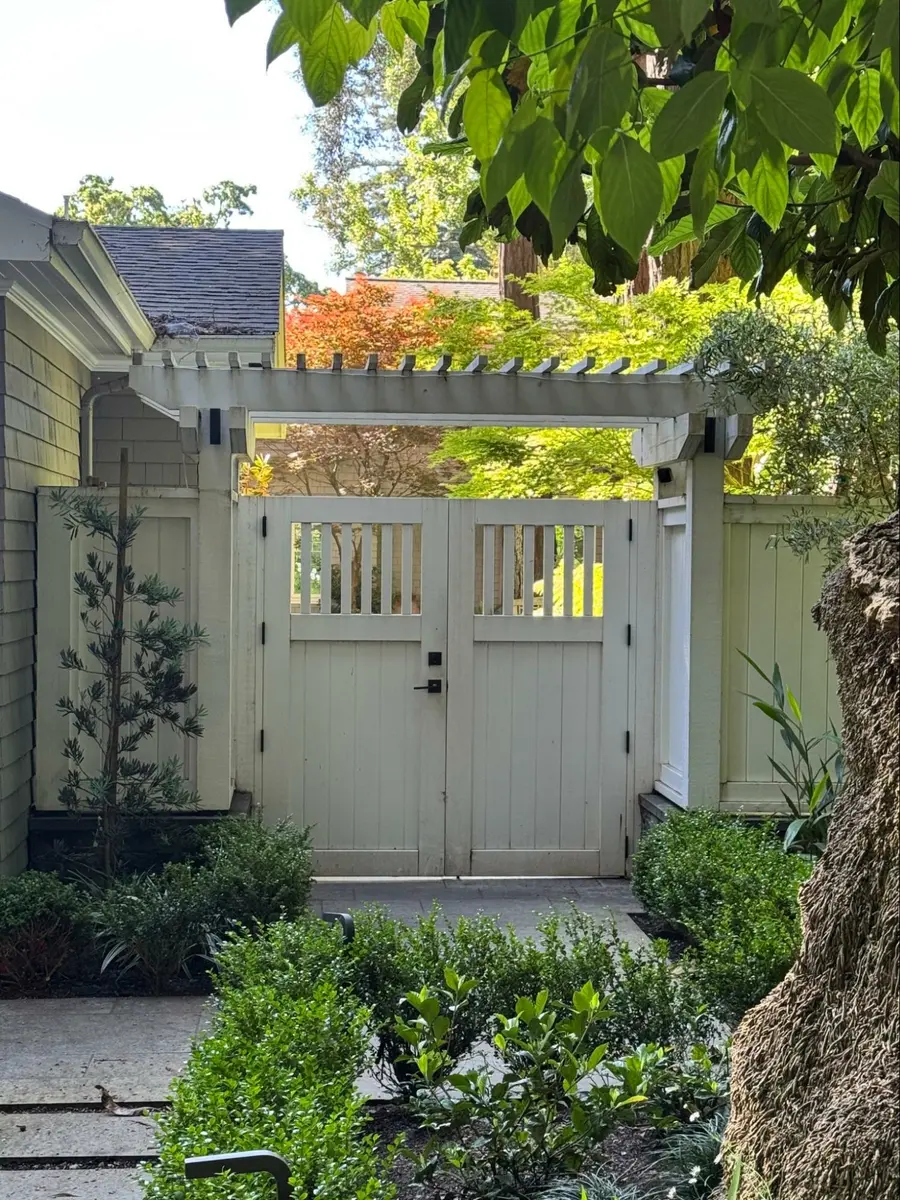 Photo credit: MetaphorEdge, Location: Marin County, California, Wood Highlights: Crisp white arbor frames a side gate, adding definition without visual heaviness