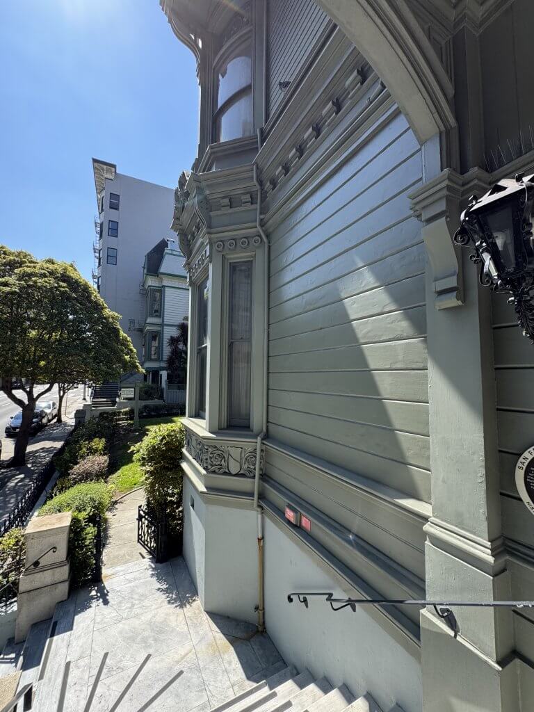 Location: Haas-Lilienthal House, San Francisco, California, Wood Highlights: Tall projecting water table moulding separates the foundation from the painted wood siding and trim above, providing exterior foundation protection and defining the historic facade.