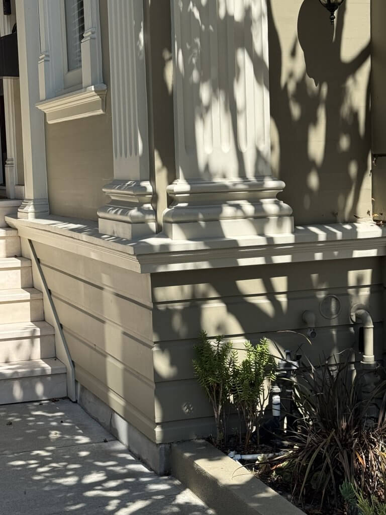Location: Private Residence, San Francisco, California, Wood Highlights: Projecting water table moulding defines the base of the historic facade, marking the transition from foundation to painted wood siding and wood trim features.