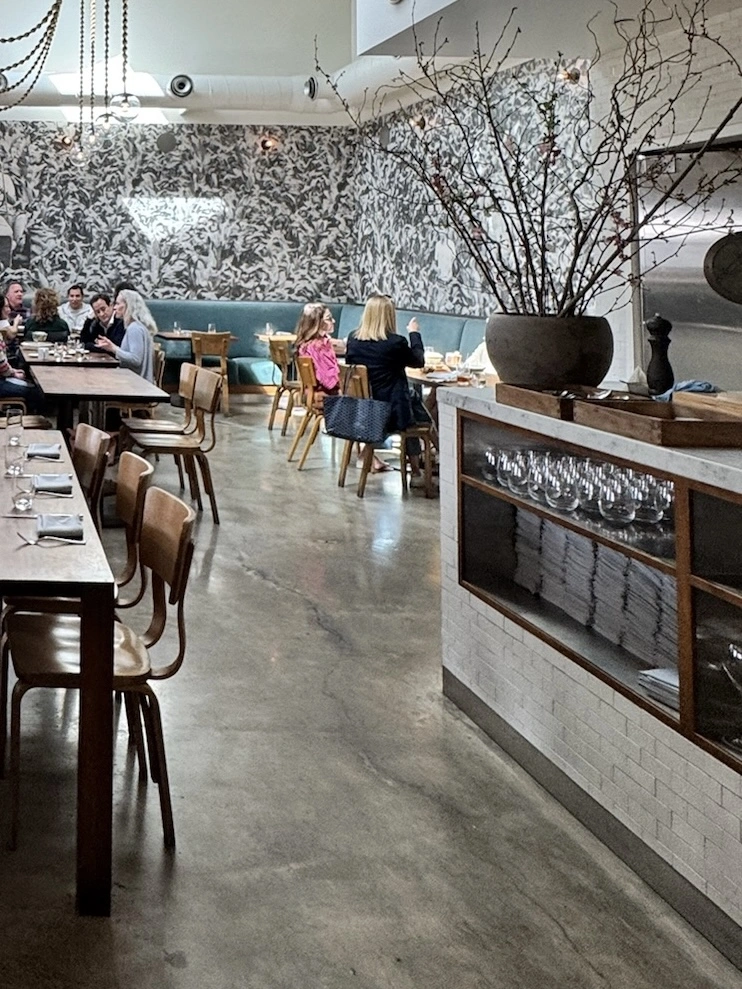 Location: Farmshop, SF Bay Area Wood Highlights: Natural wood trim design at inset shelving at this long counter adds warmth