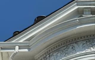 Location: San Francisco, California Wood Highlights: Detail view of wood gutter outlet integrated into ornate mouldings. The carved trim and gutter system highlight how water management was treated as part of the functional and aesthetic design.