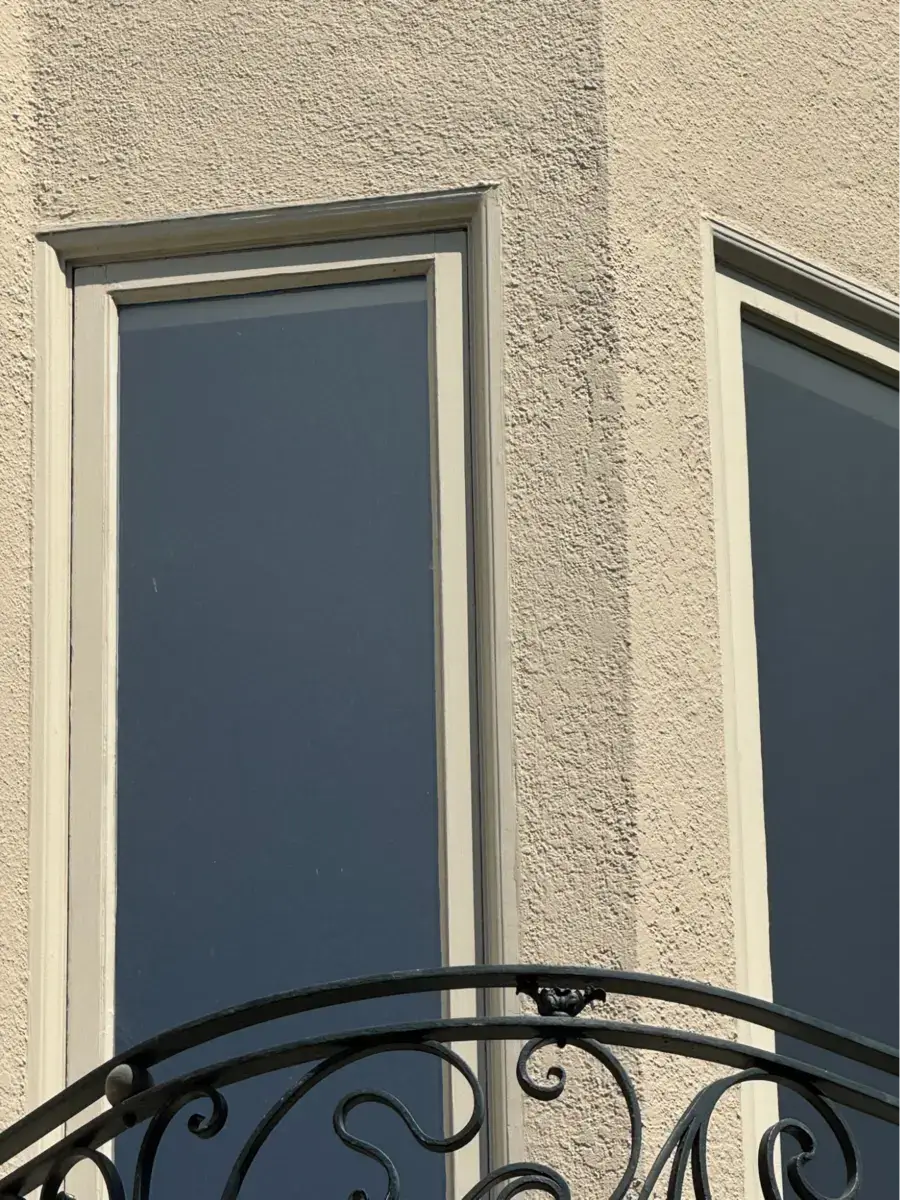 Location: San Francisco, California Wood Highlights: Detail view showing stucco mouldings framing tall windows against textured stucco. Profiles sharpen the edges, ensuring durability and a clean transition between wall and glass.