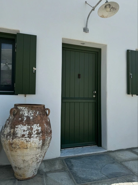 Location: Greece, Wood Highlights: Painted green wood door casing matches wood door