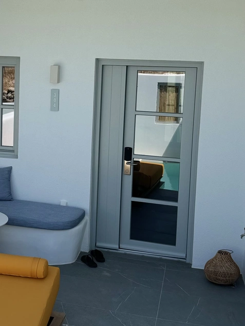 Location: Mr. & Mrs Smith, Paros, Greece, Wood Highlights: Wood door casing and trim aligns with modern door design