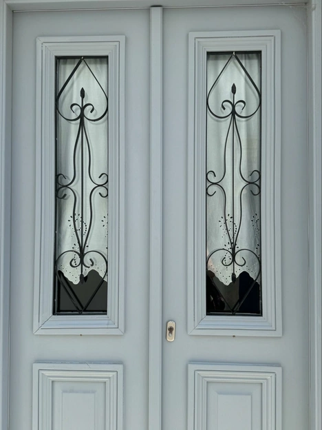 Location: Private Residence, Paros, Greece,Wood Highlights: Painted wood astragal integrates with doors