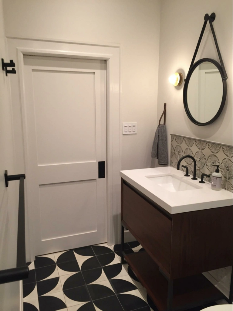 Photo credit: Metaphor Design, Location: Marin County, California, Wood Highlights: Door trim and baseboards align with main building farmhouse design in ADU bathroom