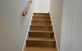 Location: Hayes Valley House, San Francisco, California, Wood Highlights: wide plank white oak floors, modern painted baseboards, natural wood stair railing matching stair treads and risers create a minimalist and serene aesthetic