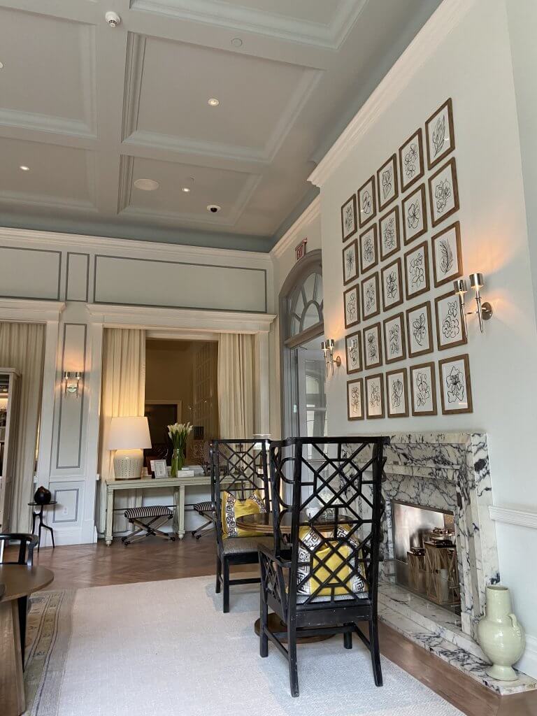 Wood Highlights: Crown moulding and a coffered ceiling top off the design, creating an airy feel above the fireplace