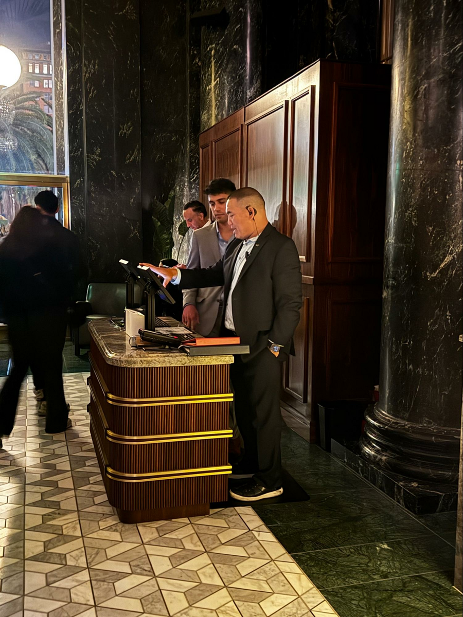 Location: Bourbon Steak, San Francisco, California, Wood Highlights: Trim behind the check-in desk calms and commands the moment with vertical lines and a trio of rectangles, paired together with the more active desk in a matching species.
