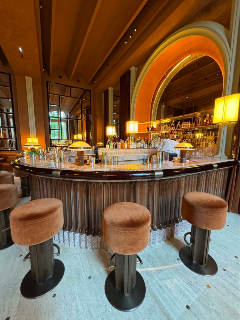 Wood Highlights: Lacquered moulding appears at the countertop edge of the bar and the lower area.